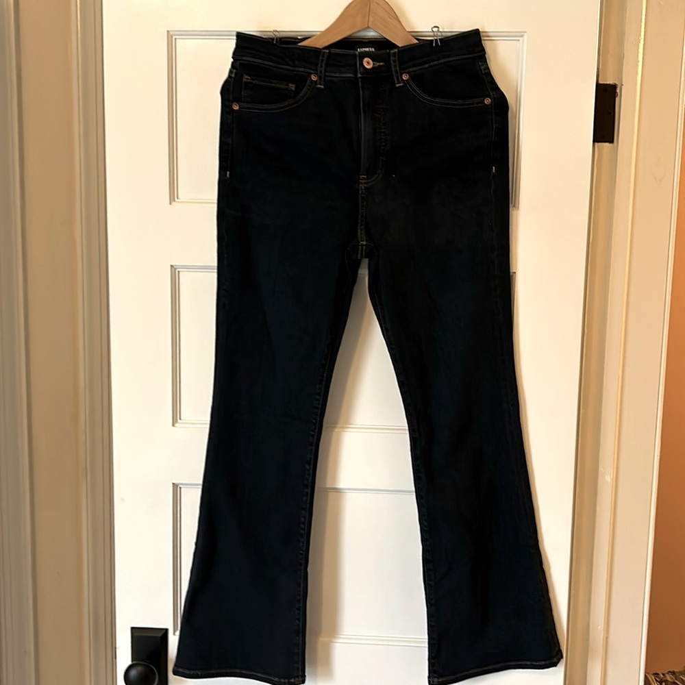 Jean boot cut by Express. Dark blue with brown stich.   Size 10 Length Short